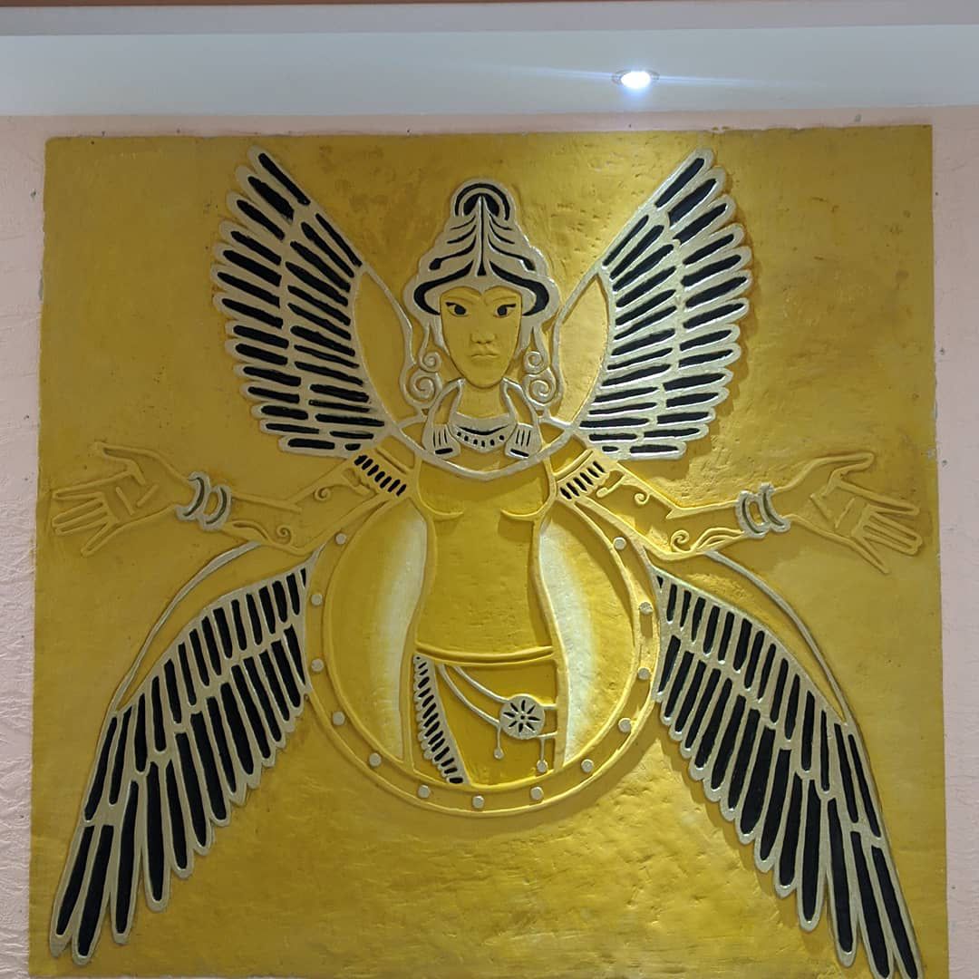Bas-relief sculpture of Ishtar, the Mesopotamian goddess, rendered in gold leaf on plaster